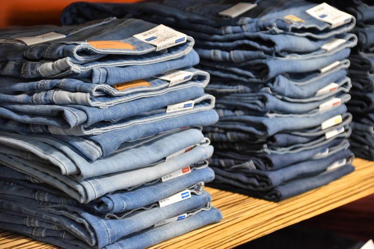 a stack of jeans | How Clothes Are Made: A Beginners Guide | APPAREL MANUFACTURING