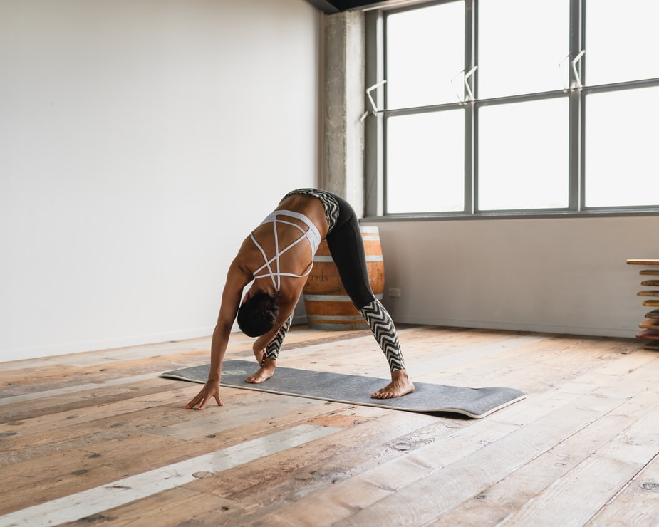 woman in athleisure wear practicing yoga 
